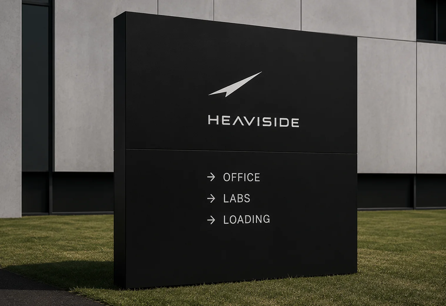 A black monolith sign outside a facility, pointing to office, labs, and loading